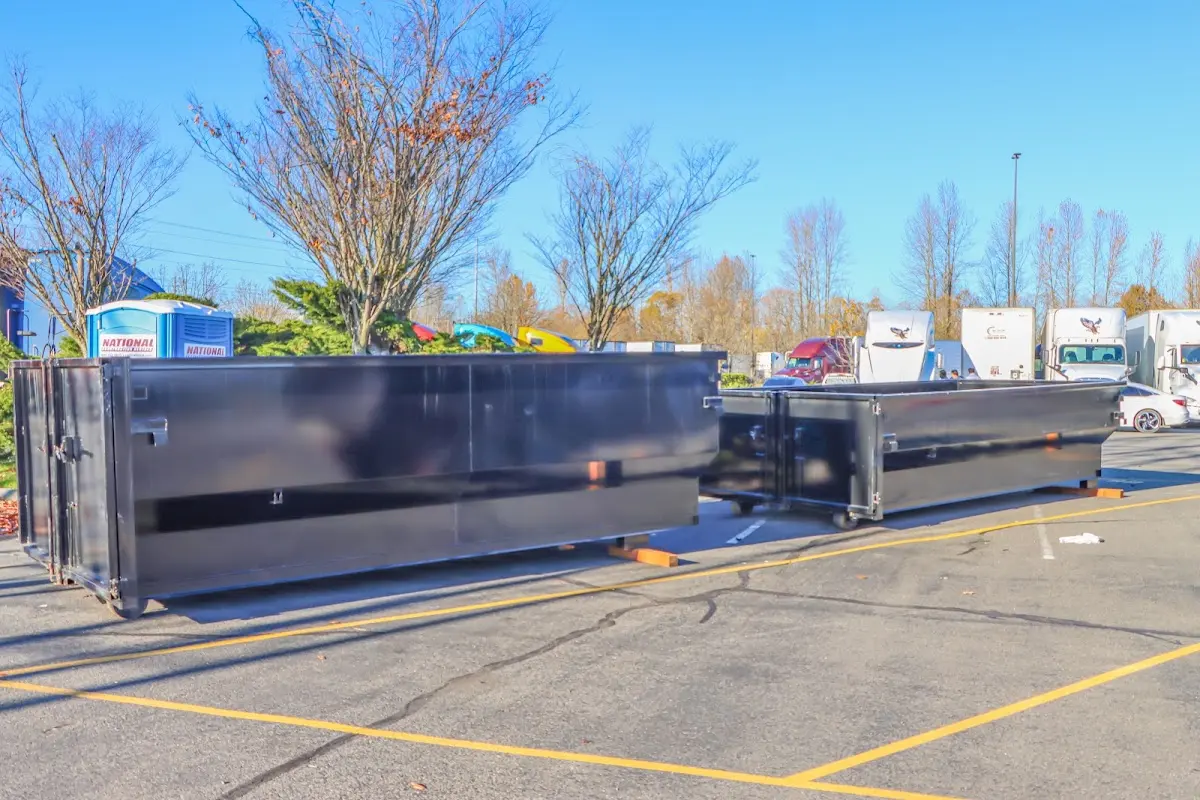 Professional dumpster rental service with roll-off container on residential driveway in St. Paul